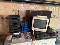 Photo of stacked black Sony mini hi-fi system components, beige Panasonic TV with rotary dial, a black Technics CD player underneath, and Pioneer speakers behind.