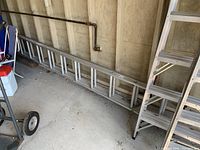 Full view of the ladder lying on the floor showing length and structure.