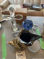 Photo showing the Oleg Cassini crystal crucifix, glass seashell bowl, and blue glass orb together on table