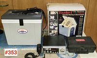 Full lot showing cooler/warmer unit, CB radio with microphone, radar detector in hard case, and original cooler box.