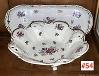 Footed serving bowl and rectangular tray together showing floral patterns and gold accents.