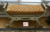 Front view of the occasional bench showing diamond tufted gold velvet upholstery and decorative painted wooden frame.