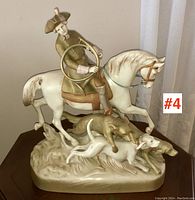 Front view of full porcelain figure showing horse, rider, and dogs