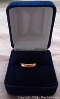 Ring displayed in blue velvet presentation box