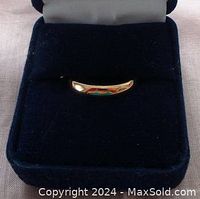 Ring displayed in dark blue velvet box