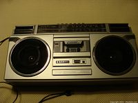 Front view of the silver and black Sanyo stereo cassette recorder showing dual speakers and cassette tape deck.