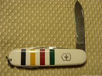 White Victorinox pocket knife with Hudson Bay Company stripes on handle and single blade extended.