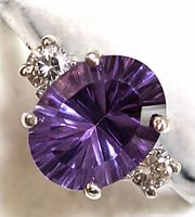 Close-up front view of oval amethyst with side diamonds