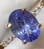 Front view of oval tanzanite center stone and diamond-set band