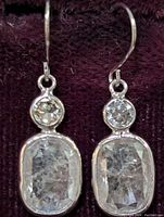 Front view of earrings showing bezel-set round and rose cut diamonds