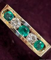 Close top-angle view showing emerald and diamond channel setting