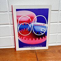 Front cover image of the Taschen Decorative Art 60s hardcover book, showing colorful 60s style design on cover.