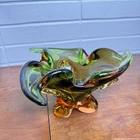 Angled front view of vintage chalet glass dish showing flowing curved edges and tricolor glass color