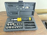 41 piece bit and socket set arranged in black hard plastic case with yellow and black handle and multiple sockets and bits visible