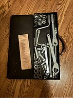Image of open heavy metal Craftsman tool box showing neatly arranged socket wrenches, ratchets, extensions, and sockets inside.