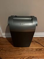 Side angled view of the GBC Shredmaster SC80 paper shredder showing the full unit against a wall on hardwood floor.