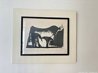 Front view of the framed print showing the black wood frame, off-white mat, and stylized bull image
