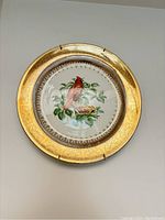 Front photo of the cardinal bird decorative plate with gold gilded rim