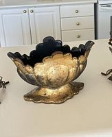 Front angle view showing the scalloped edges and pedestal base with weeping gold finish on ceramic bowl vase.