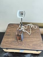 Vintage Windsor folding pyramid lamp with brown pyramid-shaped head and white interior, adjustable metal arm and base, photographed from front angle.