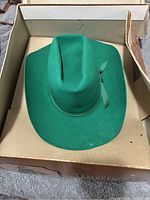 Green felt child's western hat in original box showing color and shape