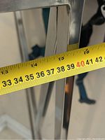 Close-up photo of tape measure across width of chrome stand showing about 40 cm.