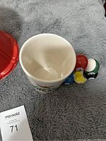 Close-up of white ceramic bingo cup with billiard balls handle