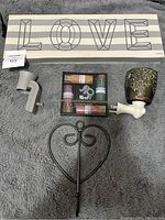 Full lot overview showing Love sign, Scentsy warmer, incense set, holder, and heart stake on gray background.