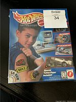 Front of sealed Hot Wheels Tattoo Designer box showing branding, child with tattoo, and CD-ROM details.