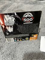 Back of the packaging showing 500 Figure logo and Star Wars themed text with some wear and a sticker.