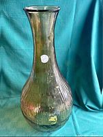Front angle of the Vidrios San Miguel hand made glass vase, showing the flared top and rounded textured body with green tint.