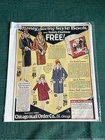 Front view of the full vintage poster in protective plastic, showing promotion for clothing and money-saving style book by Chicago Mail Order Co.