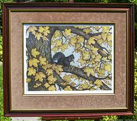 Frontal view of the framed limited edition print showing the black squirrel amidst yellow maple leaves.