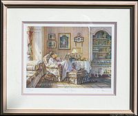 Full view of the framed print showing the woman and child in a floral armchair in a cozy room scene