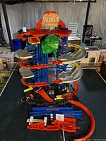 Full view of Hot Wheels Ultimate Garage playset with dinosaur head and multiple ramps.