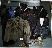 Complete lot showing jackets, vest, trousers, accessories and medals laid out on a flat surface.