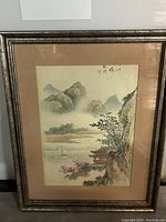 Framed full view of the Chinese watercolour landscape painting showing mountains, river, pagoda, and signature stamps.