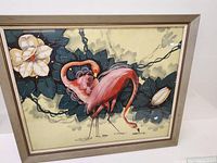 Full view of the framed silkscreen painting showing the flamingos, flowers, leaves, and frame.