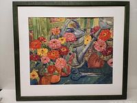Full view of framed watercolor painting showing green frame, white mat and entire floral composition.