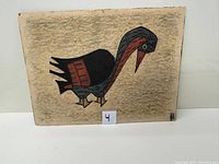 Photo of a colorful acrylic painting depicting a stylized bird with geometric shapes in black, red, and blue on a textured brownish background.