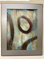 Full view of abstract modern painting on board in gray frame.