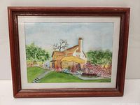 Full view of the framed watercolour painting depicting a house and garden.