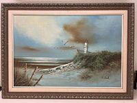 Full view of framed oil on canvas seascape painting showing lighthouse, seagulls, shoreline fencing, and dune grasses.