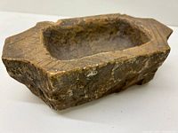 Angled top view showing carved hollow center and rough texture on surface