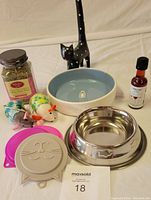 Full lot showing various cat lover items including bowls, catnip jar, kitty wine bottle, cat toys and wooden figurine