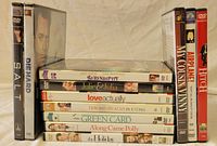 Photo showing stack of 10 DVDs including Serendipity, Julie & Julia, Love Actually, How to Lose a Guy in 10 Days, Green Card, Along Came Polly, The Holiday plus Die Hard and 5.4.7 on the side.