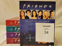 Five DVD box sets of Friends seasons 1, 2, 3, 5, and 10 stacked showing front and side colors.