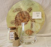 All four items: sea turtle lazy susan, candle, vase, and kitty figurine grouped together