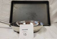 Photo showing the 10 inch stainless steel frying pan in front of the 9x14 baking sheet.