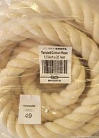 Close-up photo of twisted cotton rope with label showing size and brand under clear plastic packaging
